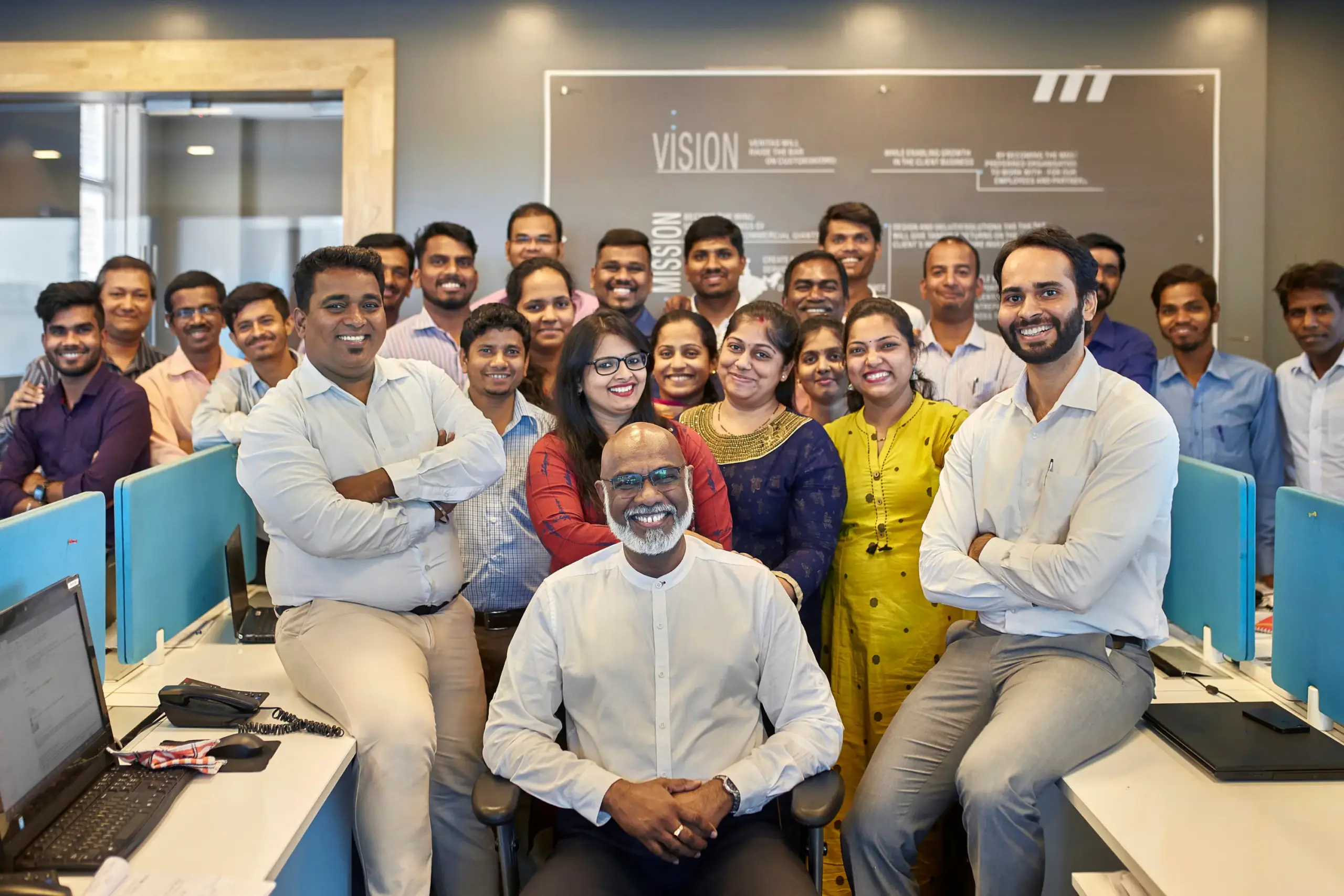 Office team posing together in a modern workspace